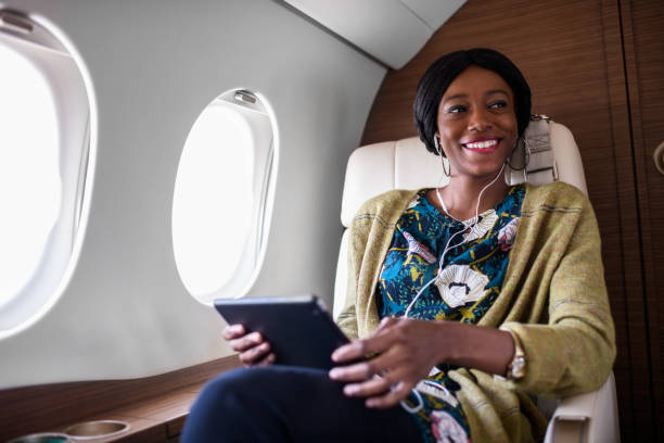 istock Woman in private jet airplane 883731722
