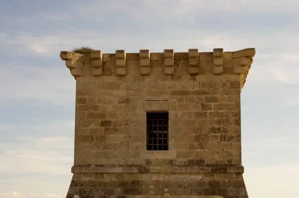 Outdoor architecture of an ancient Venetian tower in Cyprus and cloudy blue sky