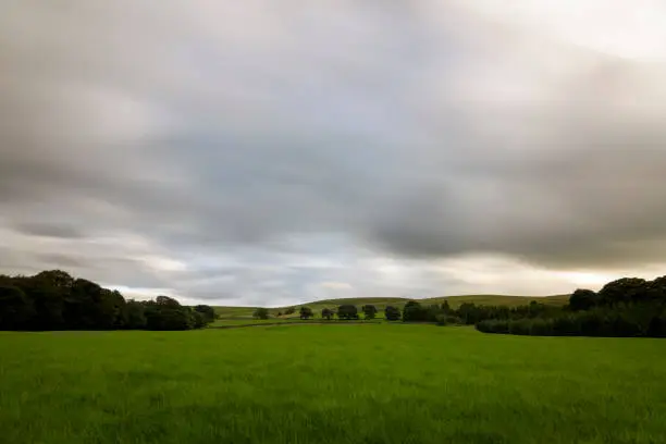 Photo of Clouds long exposure over british green countryside England