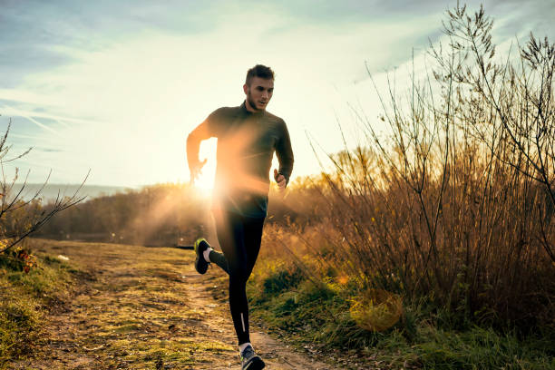 Morning jogging Man running in nature track event photos stock pictures, royalty-free photos & images