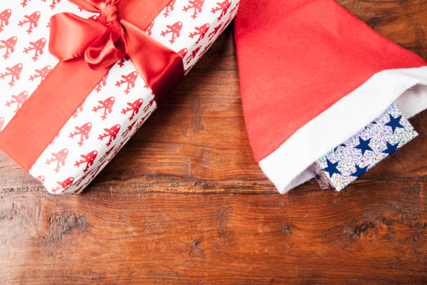 istock Gifts and a hat lie on a table, top view, close up 883744100