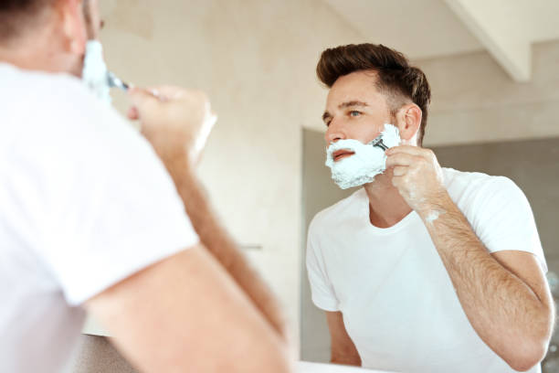 say bye to the beard - shaving men shaving cream mirror imagens e fotografias de stock