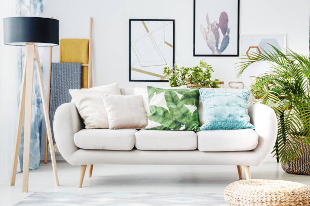 istock Floral cushion on beige sofa 883744344