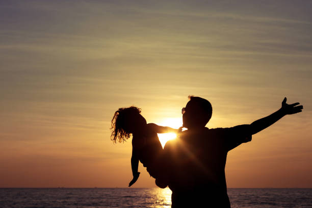 istock Father and son playing on the beach 883754170