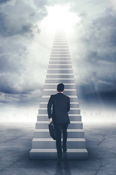 istock Businessman walking upward on the stair 883766174