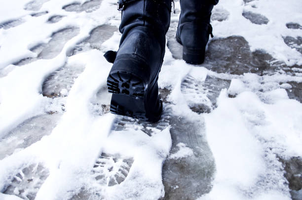 istock Dirty footprints in the snow winter. Track from boots on the tra 883766440