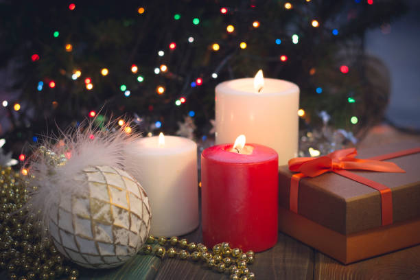 istock Still life with burning candles, Christmas decorations and a gift box 883774612