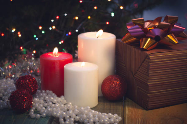 istock Still life with burning candles, Christmas decorations and a gift box 883775214