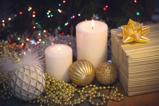 istock Still life with burning candles, Christmas decorations and a gift box 883776432