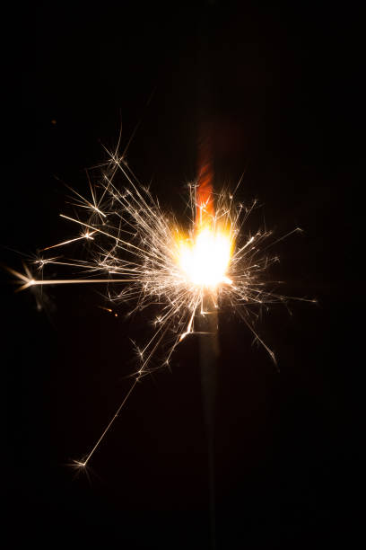 istock Sparkler or bengal light burning over black 883776450