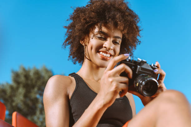 istock Athletic african-american woman with camera 883781992