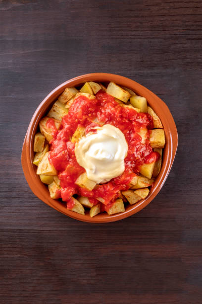 istock Patatas bravas, Spanish potato dish, overhead shot 883789244