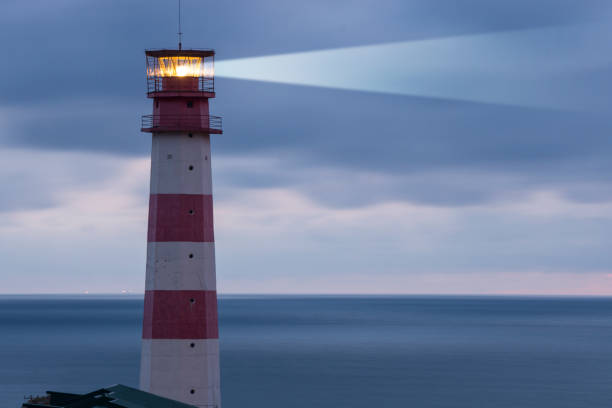 istock Lighthouse searchlight beam through marine air 883789818