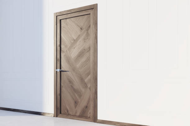 istock White walled room with a wooden door 883790860