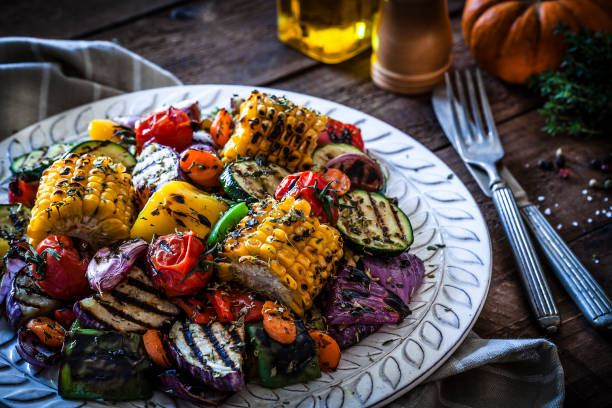 istock Grilled vegetables plate shot on rustic wooden kitchen table 883802094