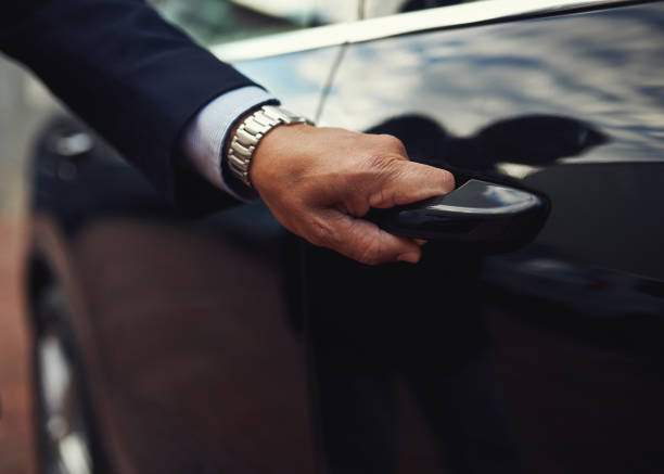 Travel in top class style Cropped shot of a businessman opening a car door black taxi stock pictures, royalty-free photos & images