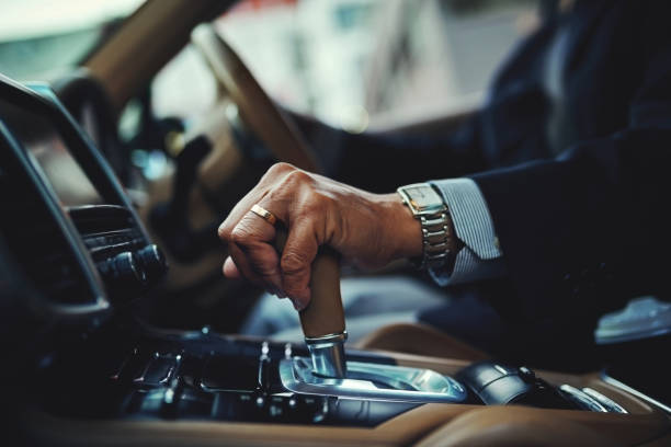 All geared and good to go Cropped shot of a businessman changing the gears of a car luxury lifestyle stock pictures, royalty-free photos & images
