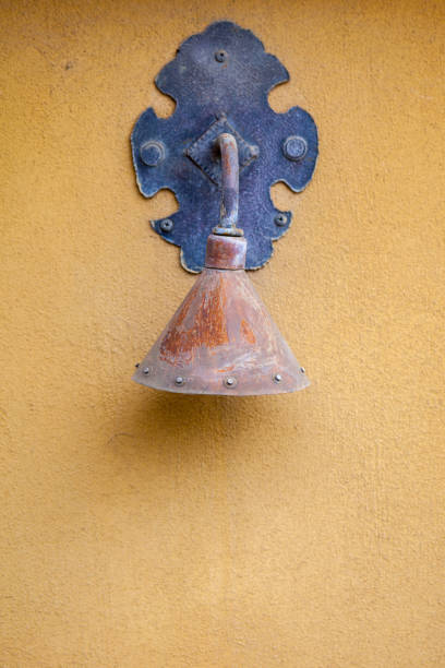 istock Ornate Antique Light On Yellow Wall 883810100