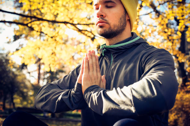 istock Young man meditation in nature. Eyes closed. 883817648