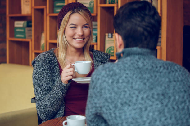istock Young romantic couple flirting over coffee 883821232