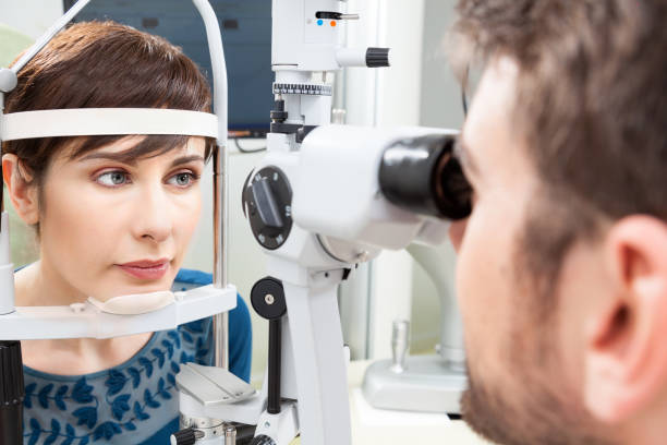 istock Beautiful woman having an eye exam 883827868