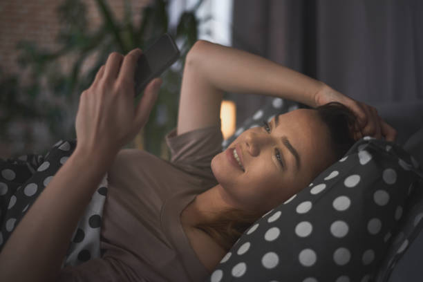 istock Girl using smart phone in bed 883828900