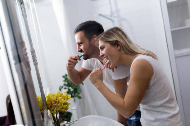 istock Attractive couple brushing teeth in morning together 883832648