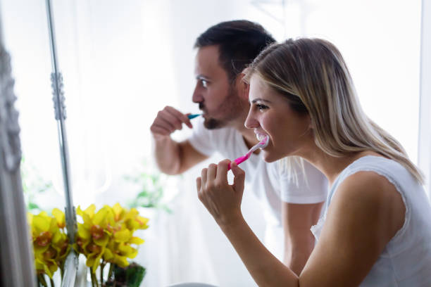 istock Attractive couple brushing teeth in morning together 883832740