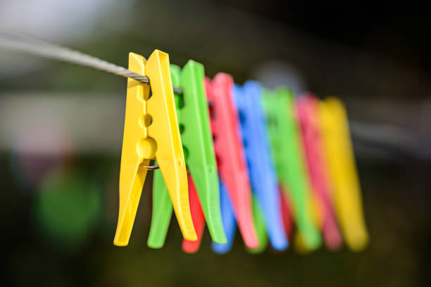 istock Colorful pegs on clothesline 883833420