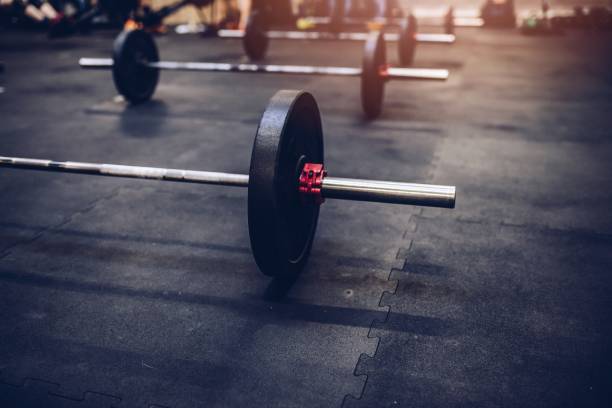 istock Close up on barbell on the floor 883834770