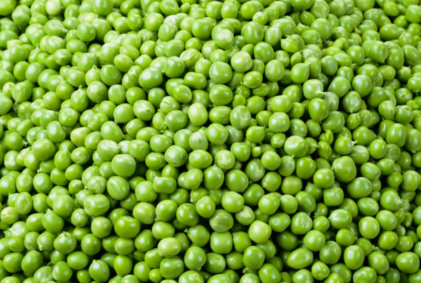 istock Green Peas. Peas background. Vegetable background. Top view. 883840026