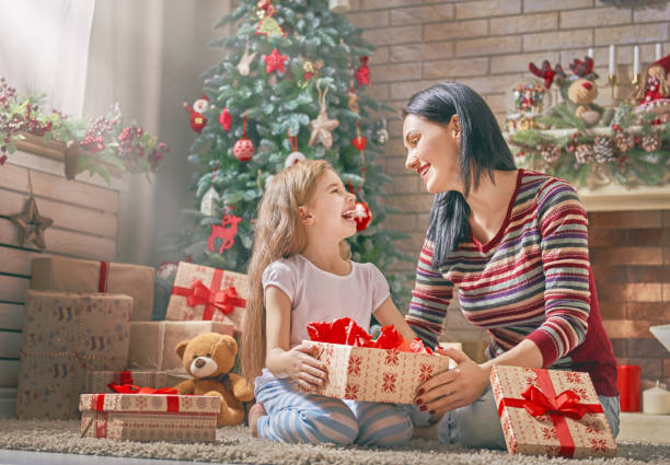 istock Mom and daughter near Christmas tree 883841840