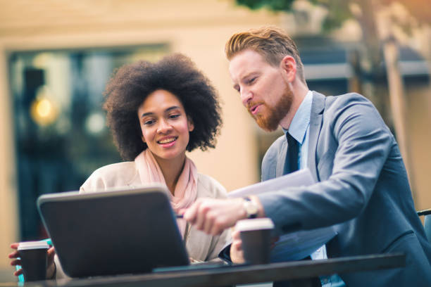 istock Business people using laptop outdoor. 883850620
