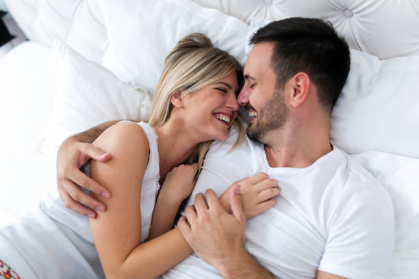 happy couple having romantic times in bedroom - sensuality lifestyles cheerful comfortable imagens e fotografias de stock