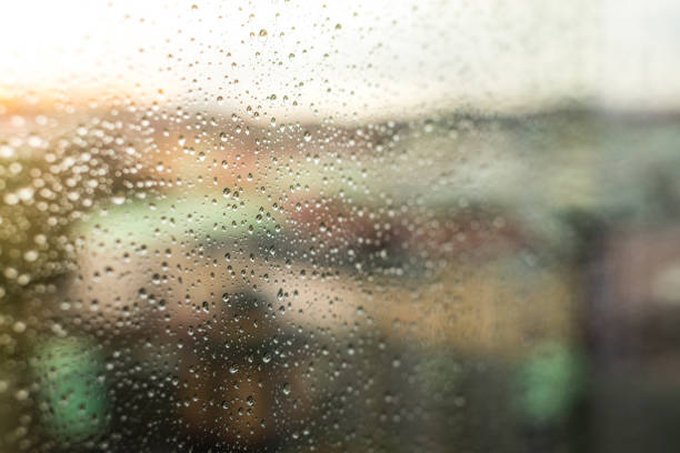 Looking at the city through rainy window perspective