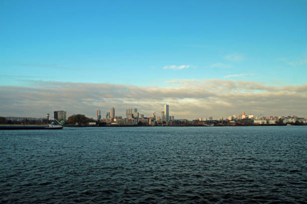 istock Skyline of Rotterdam in wide angle with blue sky and white clouds 883872304