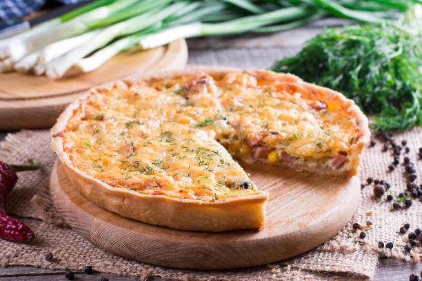 istock Traditional french quiche pie with with cheese and bacon on cutting board 883872306