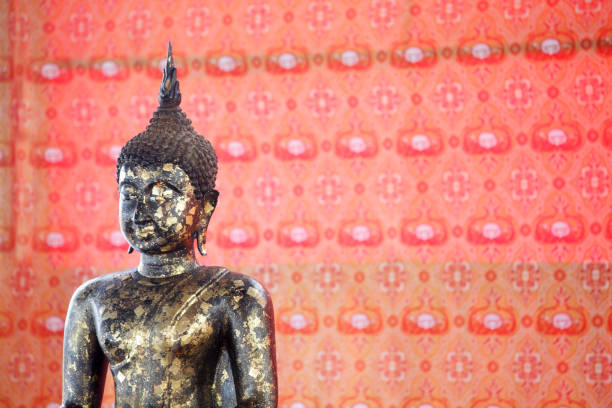 istock gold leaf buddha statue with old tradition background. 883886770