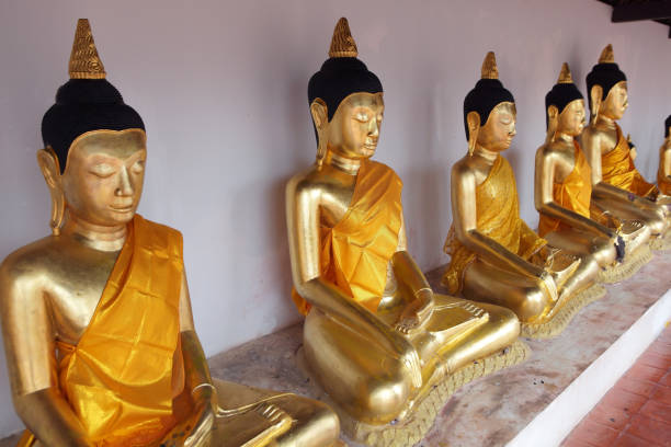 istock row of tradition golden buddha statue as background. 883886818