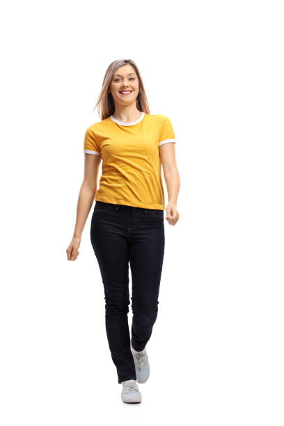 istock Young woman walking towards the camera and smiling 883887338