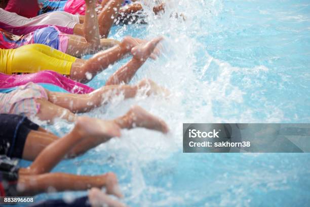 Group Of Children At Swimming Pool Class Learning To Swim Stock Photo - Download Image Now