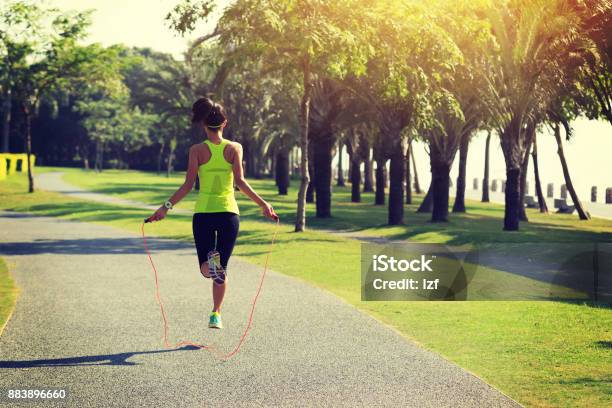 Young Fitness Woman Jumping Rope At Tropical Park Stock Photo - Download Image Now - Active Lifestyle, Activity, Adult