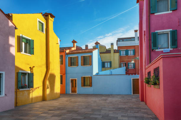 alleys of colorful buildings of burano, venice, italy - architecture vibrant color bright built structure imagens e fotografias de stock