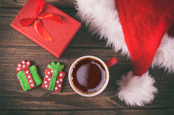 istock Christmas coffee and gingerbread cookies on rustic wooden table 883898254