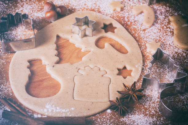 Baking Cookies with Gingerbread Christmas Cookie Cutters in Dough