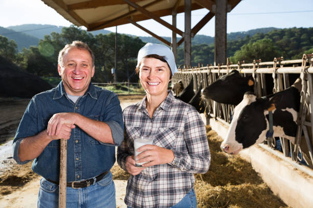 istock male and female workers posing on cow farm 883906682