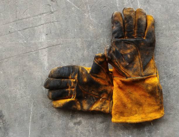 istock leather glove after work hard on dirty cement ground 883917064
