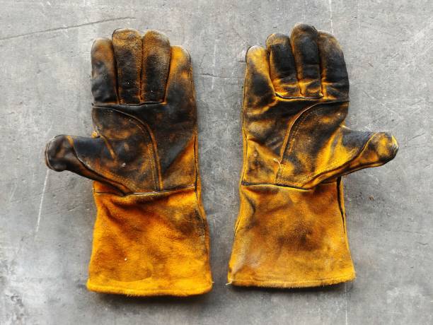 istock leather glove after work hard on dirty cement ground 883917066