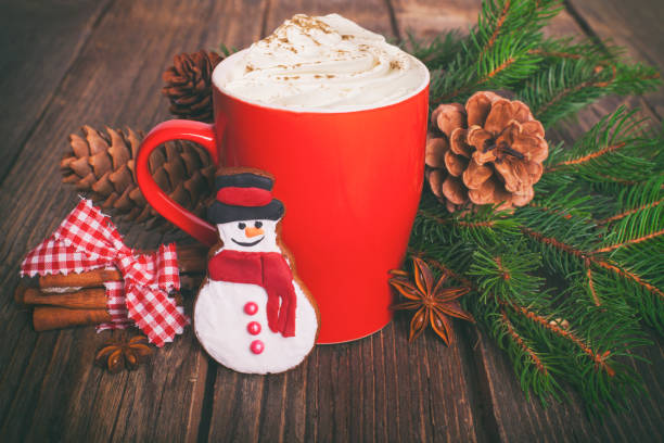 istock Christmas cappuccino and gingerbread cookies on rustic wooden table. 883917162