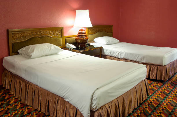 Double bed with table lamp in the bedroom at night time